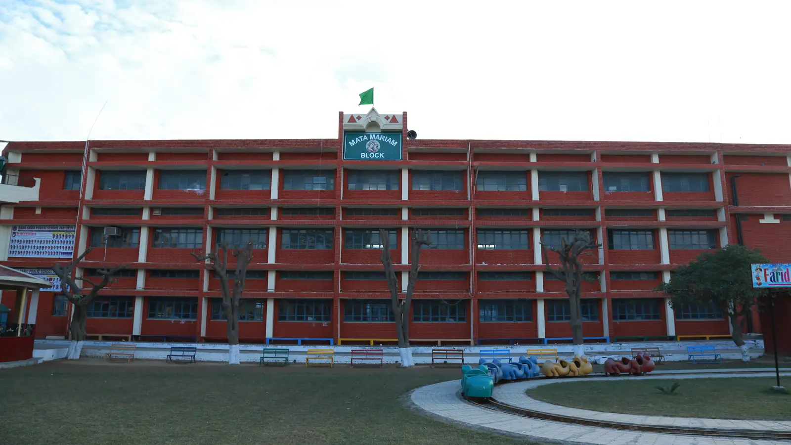 Mata Mariam Block, a long three-storey school building with a lawn