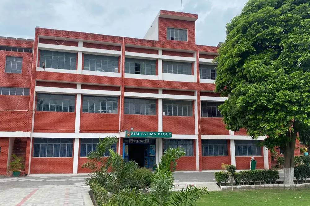 Bibi Fatima Block, a red-brick building with a garden in front