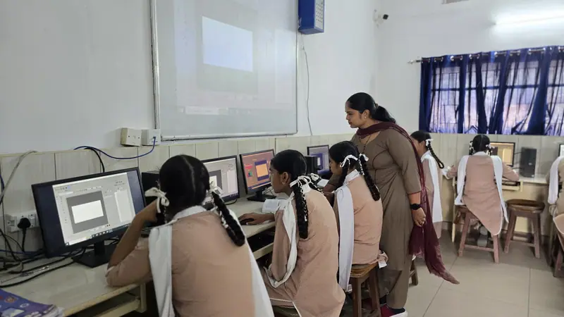 Rows of computers with students in the computer lab