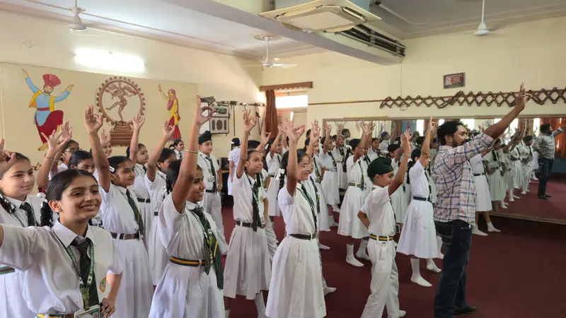 A group of students dancing together in the dance room