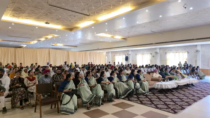 The Farid Auditorium filled with seated students