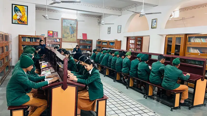 Students reading at tables in the library