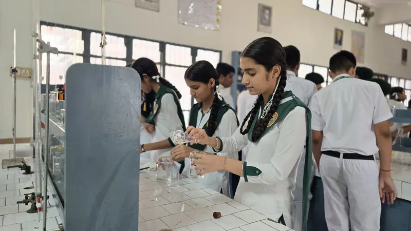 A student looking through a microscope in the biology lab