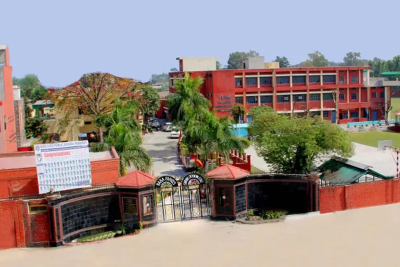 The main school building of Baba Farid Public School with lawns in front