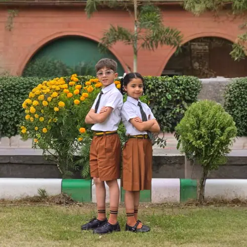 Two students in the summer school uniform standing in the school garden